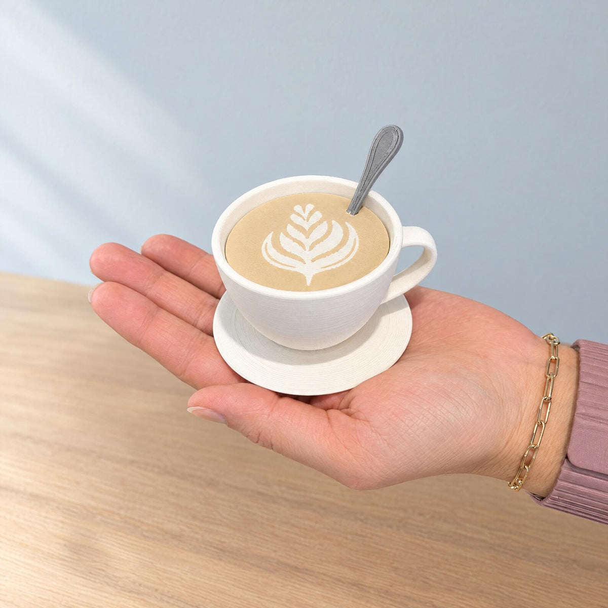 Small white coffee cup storage container held in a hand