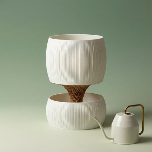 White ribbed Pallas planter with a tan wavy core above its matching bowl, beside a small watering can