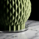 Green textured vase on a marble surface with a dark background