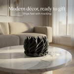 Decorative black vase on a marble table with a living room background