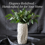 Textured white vase with greenery on a dark background, promoting handcrafted art for home.