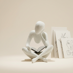 White abstract sculpture sitting on a beige surface with a light background