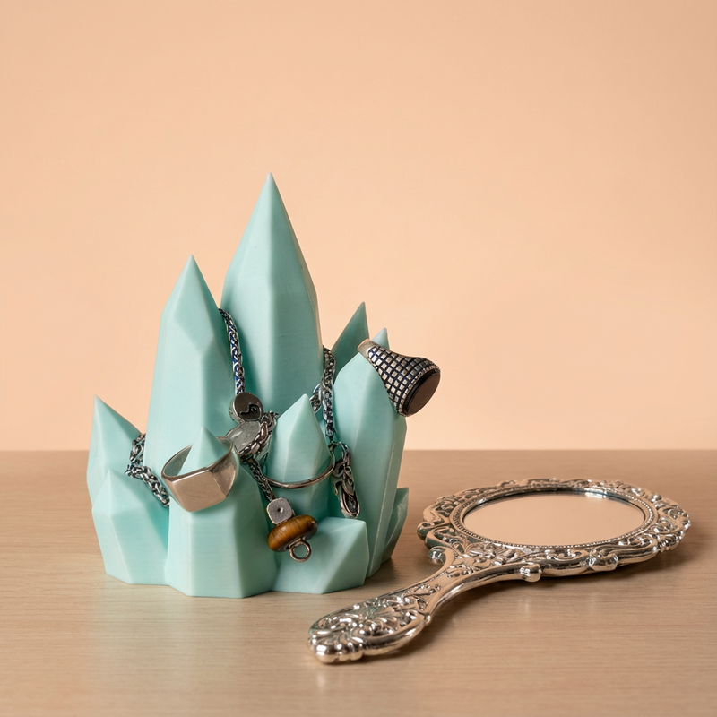 Jewelry holder with necklaces and a decorative hand mirror on a wooden surface.