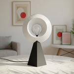Modern table lamp with black base and white ribbed shade in a living room setting.
