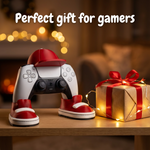 Gaming controller with red shoes and a gift box on a wooden surface with blurred lights in the background.