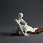 White seated NObody Reflection figure beside an open notebook against a dark gray background