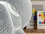 Close-up of textured material with a blurred background featuring abstract art.