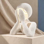 White NObody Lamp on a stone display block with neutral fabric backdrop