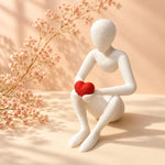 White Love’s Embrace figure holding a red heart beside delicate flowers