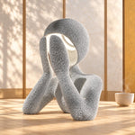Marble NObody Lamp on a wooden table in warm sunlight