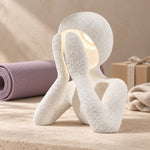 White NObody Lamp beside a lavender yoga mat