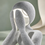 Close-up of the textured Marble NObody Lamp against a green backdrop