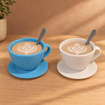Blue and white cup-shaped storage containers with latte-art lids, spoons and saucers