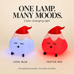 Two elf hat garlic lamps glowing cool blue and festive red, with on-image text reading "One lamp. Many moods." and "Color-changing light". A garlic lamp shown in two lighting colors.