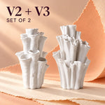 Two white matte textured coral-style bud vases with ruffled, multi-tiered openings and the text "V2 + V3 SET OF 2" in the upper left corner.