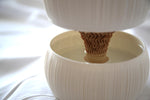Close-up of the Pallas planter's tan core sitting in water inside the white reservoir bowl