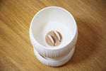 Top view inside the white Pallas planter, showing two white wick loops over the tan center insert