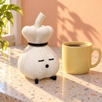 Chef garlic lamp beside a yellow mug on a kitchen counter