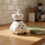 Chef garlic lamp on a kitchen table next to a green book